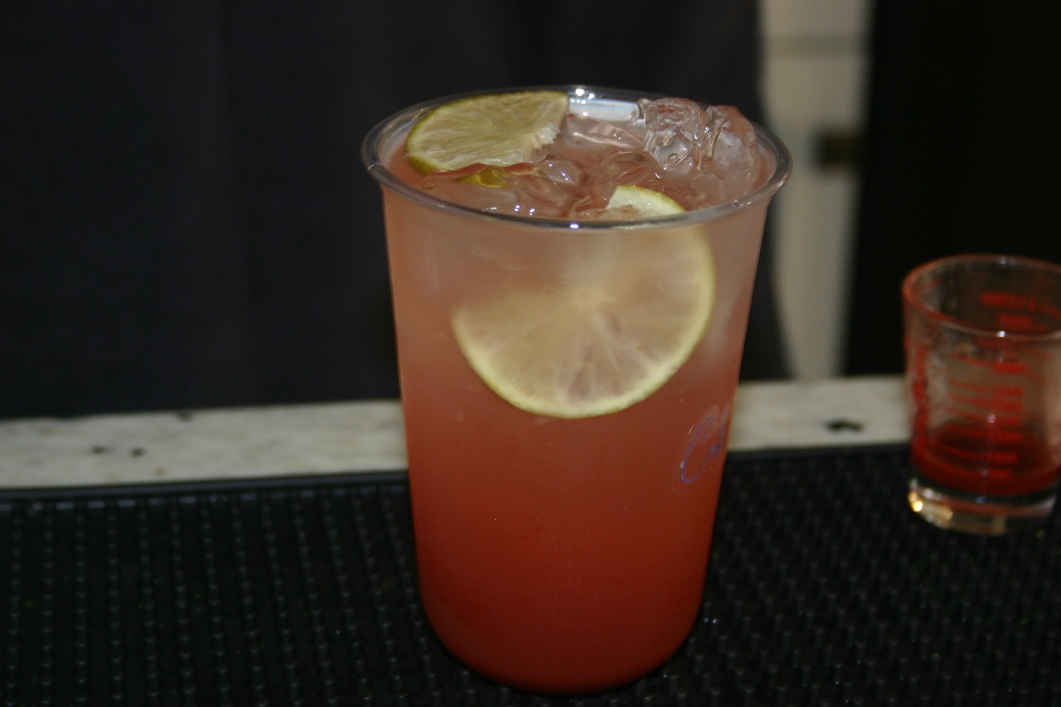 Pink iced drink with lemon slices